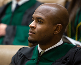 A student in a green robe