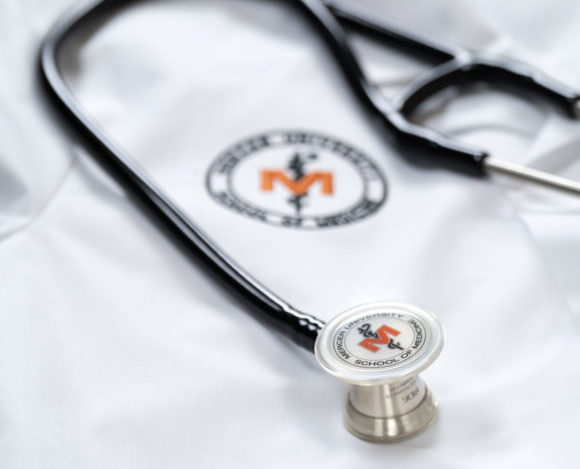 School of Medicine white coat with a stethoscope on top