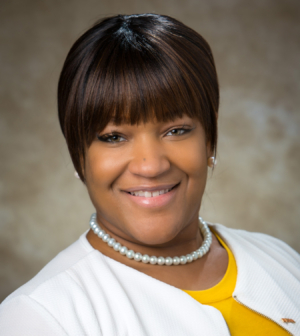 Kenya Jones in yellow shirt smiles for the camera