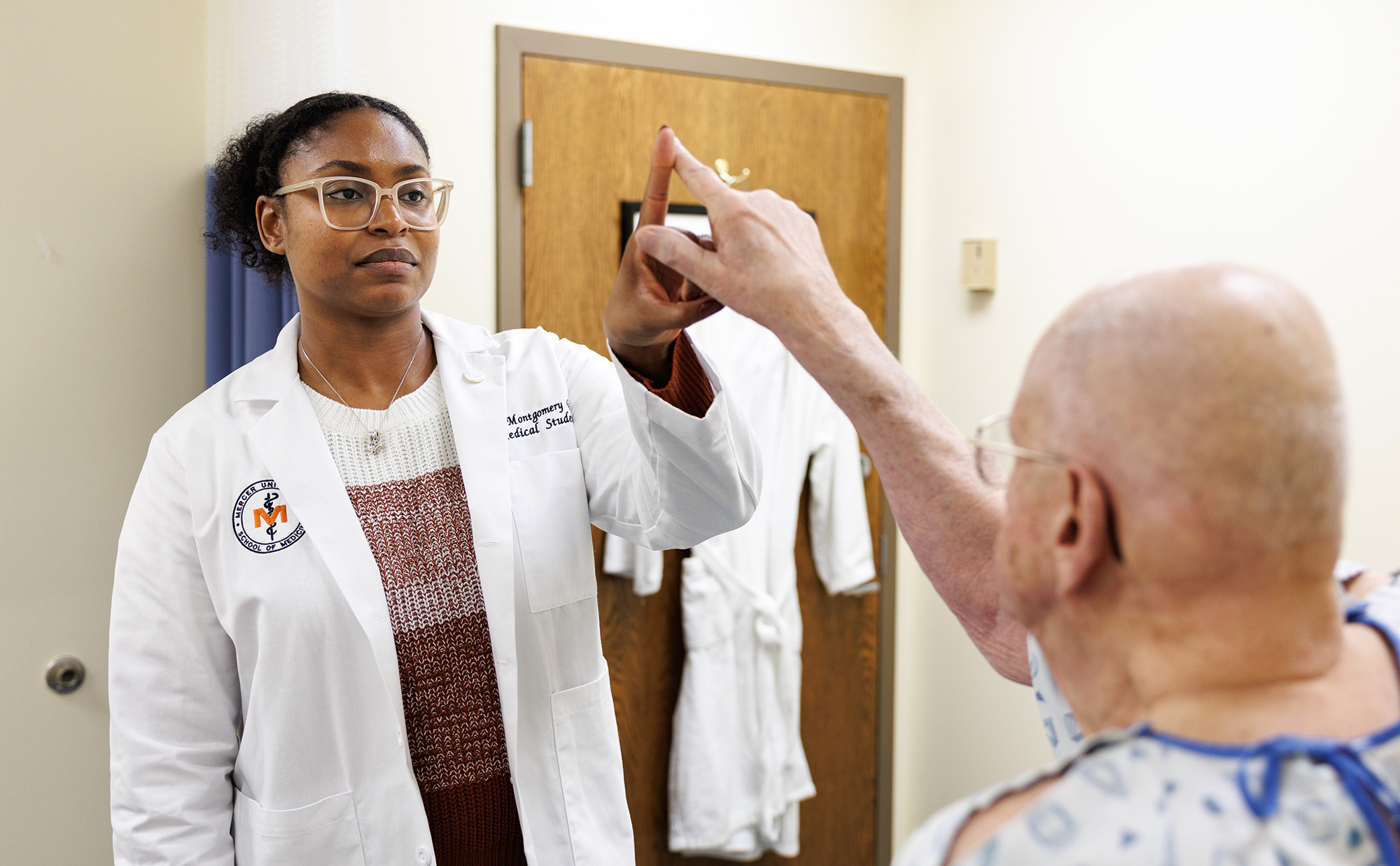 Medical Student checks older patients balance