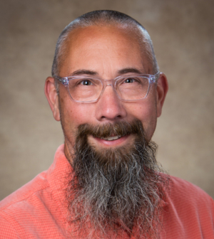 Michael Kramer in red shirt with glasses on.