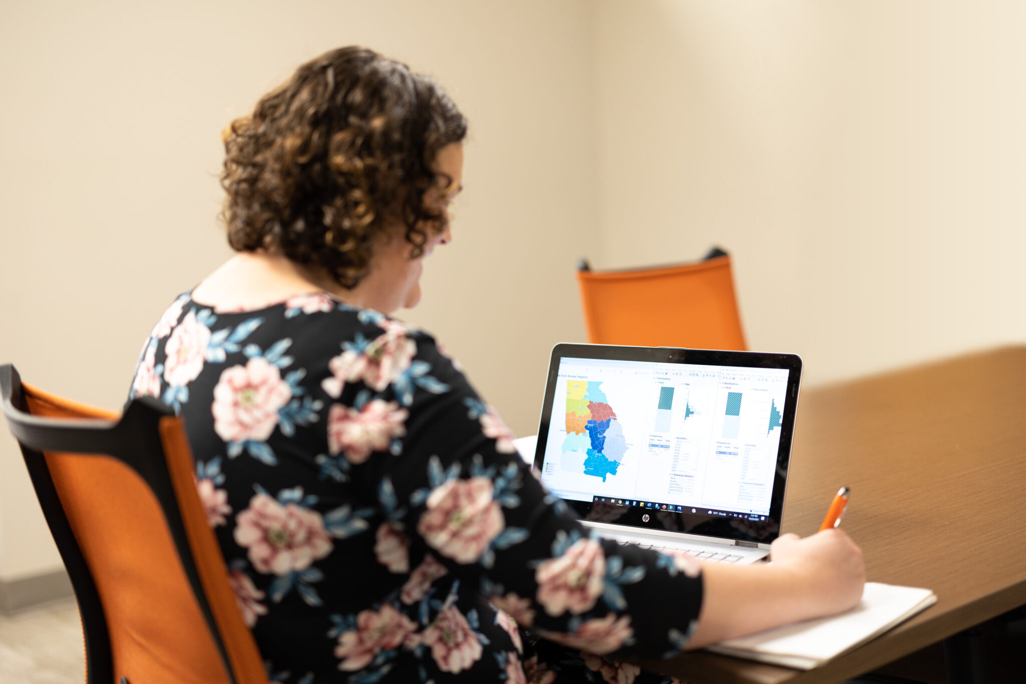 woman using a laptop to study a map of georgia