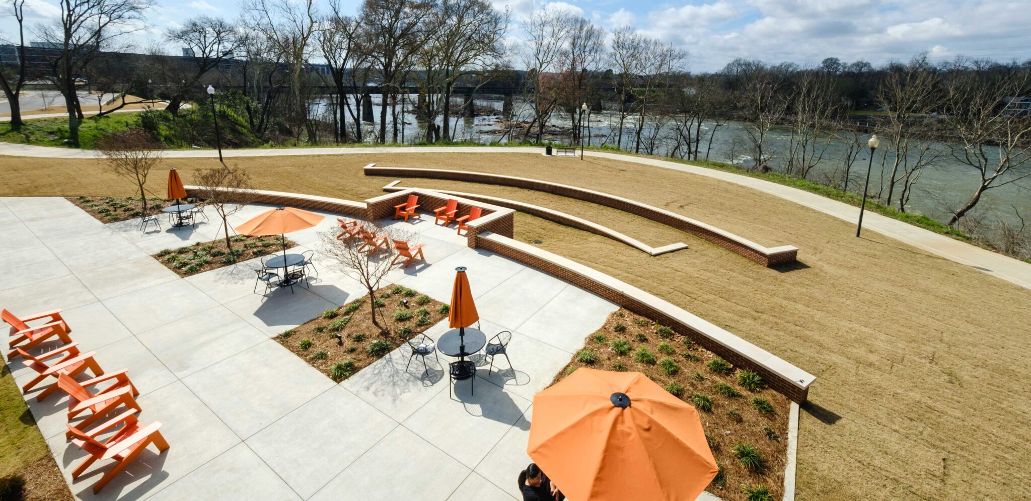 Outside patio with tables, umbrellas and river view