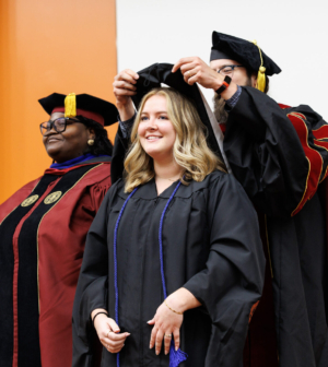 MFT student during hooding ceremony