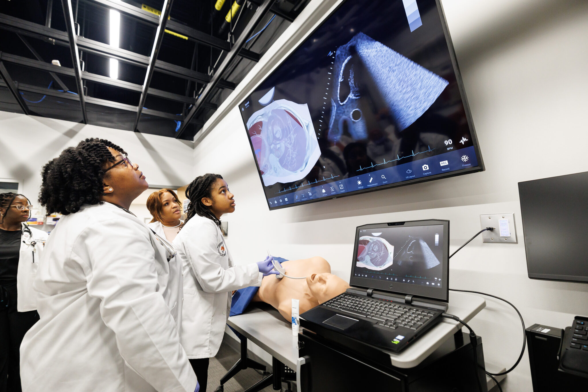 medical students watching ultrasound results on a screen