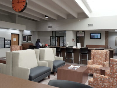 Big open room with seating areas with long tables.