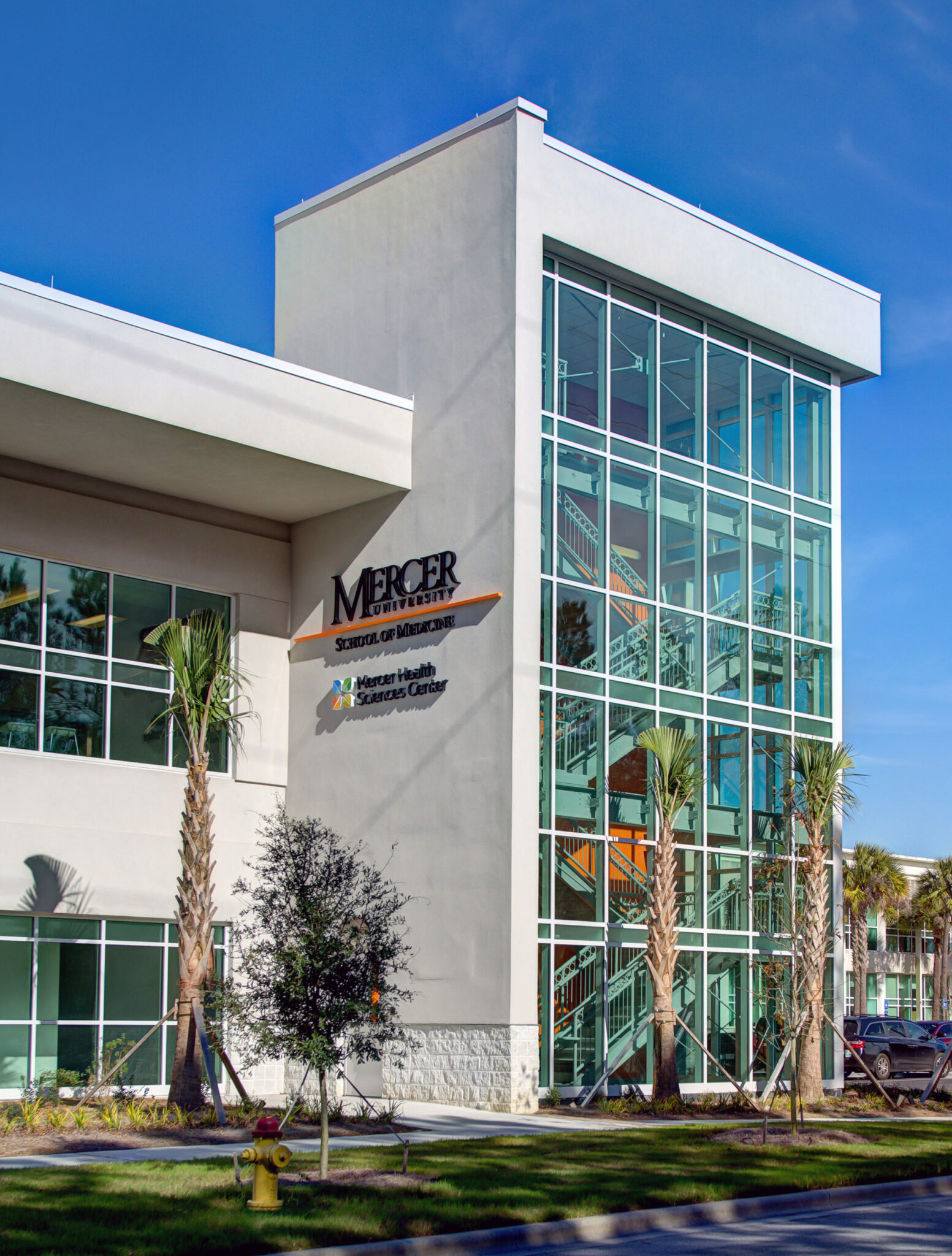Savannah white campus building with windows and Mercer University School of Medicine sign.