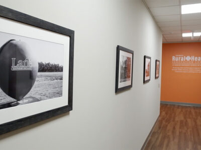 Hallway with black and white photos of rural Georgia on the wall.