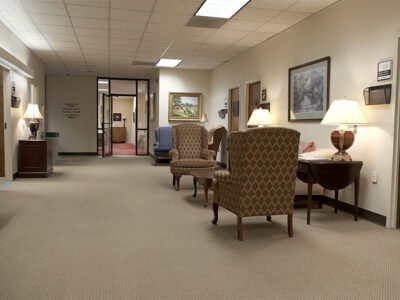 Open room with seating area and offices on all sides.