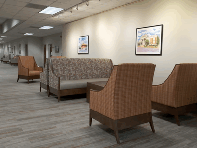 Open room with seating areas and pictures on the wall.