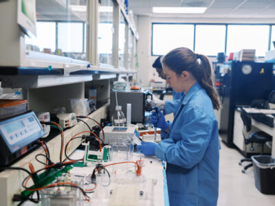 Students at table in research in lab.
