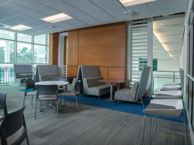 Community space with several tables and booths for eating.