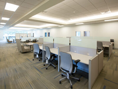 Large room with many office cubicles.