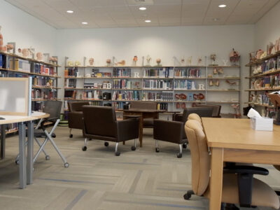 Library with seating areas and wall of books