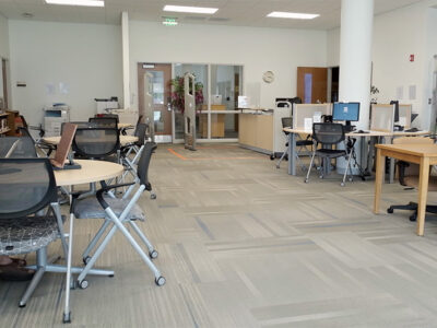 Inside campus library with door and seating areas.