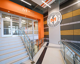 Inside lobby with stairs and MUSM Seal on wall