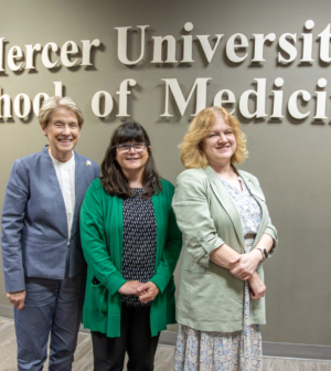 Dr. Sumner, Dr. House and Dr. Meeks smiling in front of a Mercer University School of Medicine sign
