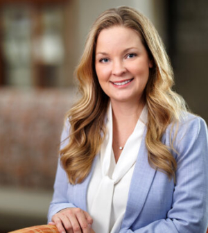 Dr. Stephanie Beavers wearing a blue jacket and white top, smiling in the lobby of the Mercer University School of Medicine